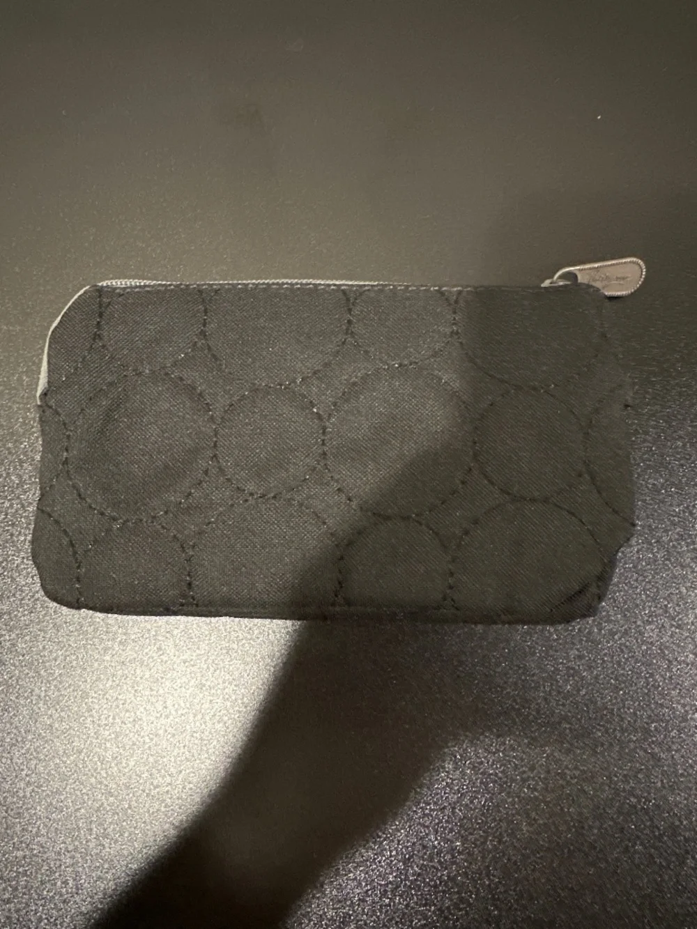 Black quilted wallet with grey zipper